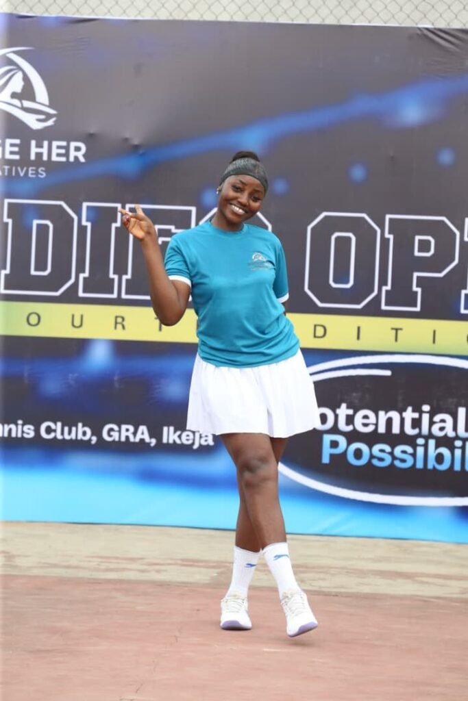 A player poses with her racket in front of the Lagos Ladies Open banner
